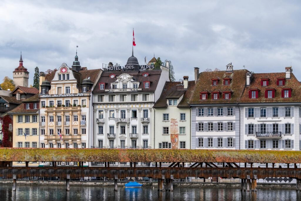 Scenic view of historic buildings and Chapel Bridge in Lucerne, embracing Swiss architectural charm.